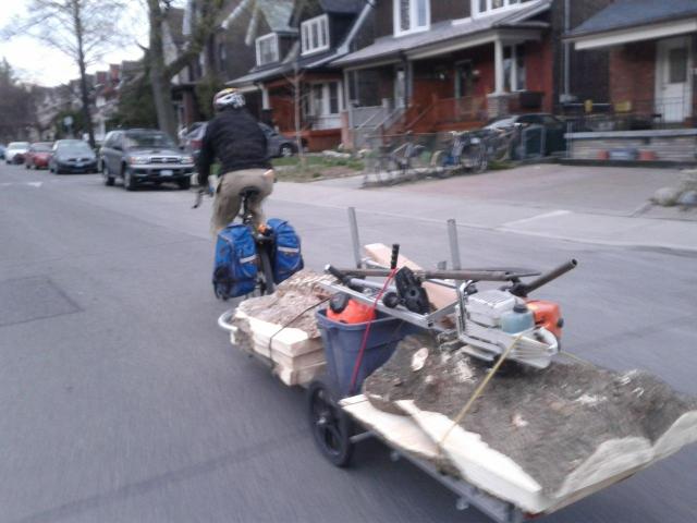 Dennis Hale carrying slabs of wood and his portable mill on his 96A (sans fenders!)